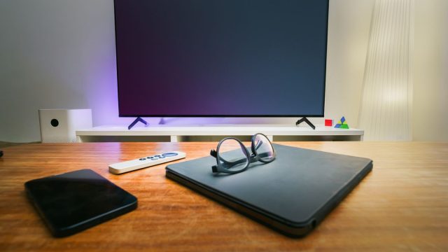 Modern smart TV in a cozy living room with smart devices, available to buy on deposit