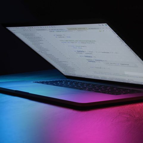 Open laptop illuminated with neon lights, available to buy on deposit